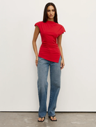 Red Liana top displayed on a hanger, showcasing its vibrant color and stylish design.