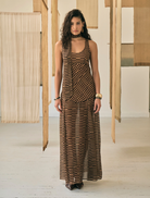 The Driftline Maxi Sun Dress displayed on a mannequin, featuring a colorful pattern and a long, elegant silhouette.
