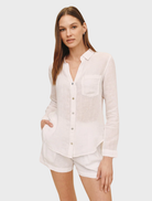 White linen button-down shirt with a pocket, featuring a classic collar and relaxed fit for casual wear.