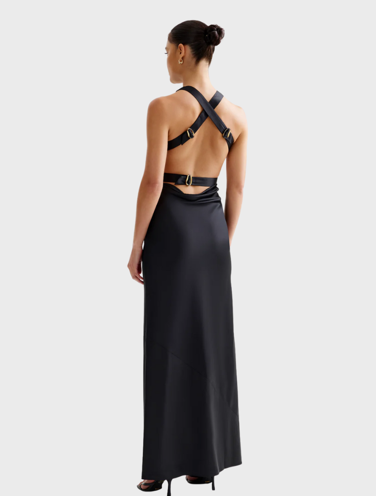 A black stretchy fabric dress, the Liora Dress offers elegance and flexibility in its design.