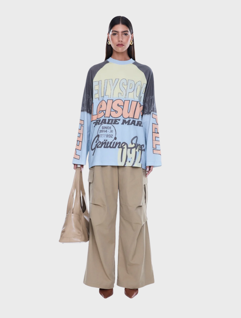 Relaxed fit Trademark Long Sleeve Tee with raglan sleeves, classic crew neckline, and vibrant all-over yardage print.