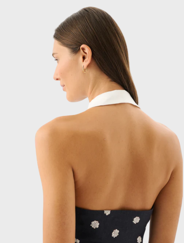 Riviera's Lucille Mini Dress showcases a trendy design, perfect for summer outings with its bright colors and flattering fit.