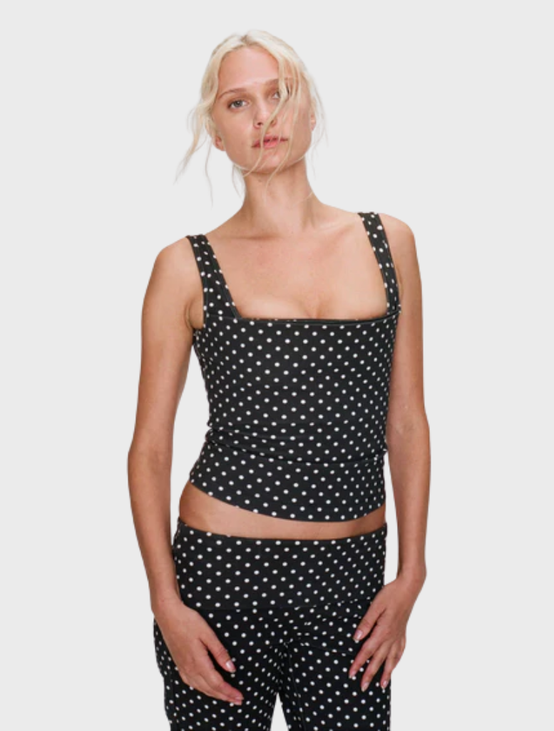 Fashionable black top with a subtle small dot pattern, offering a modern touch to any outfit.