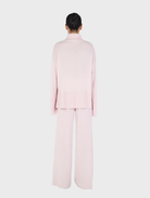 Blush Bay Cashmere Jumper displayed on a hanger, showcasing its soft texture and elegant design.