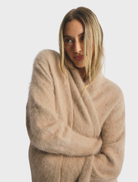 Latte-colored Sophia Open Cashmere Cardigan, featuring a relaxed fit and soft texture, perfect for layering in cooler weather.