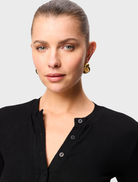  Black Lyon Cardigan displayed on a hanger, featuring a classic design with long sleeves and an open front.