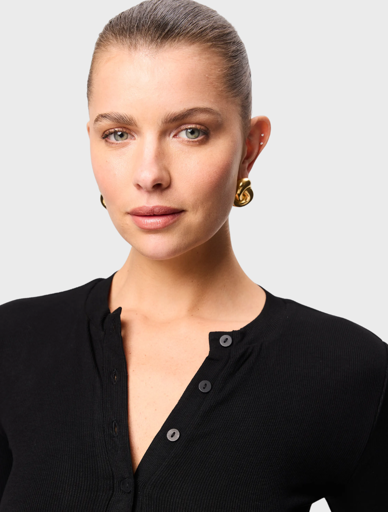  Black Lyon Cardigan displayed on a hanger, featuring a classic design with long sleeves and an open front.