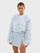 Manhattan Crop Jacket in powder blue, designed with marabou feathers and a cropped silhouette, ideal for special occasions.