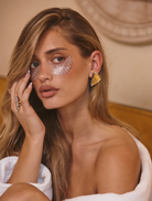 A diamond ring with three stones in gold and white gold, identified as the Marais Triple Statement Ring.