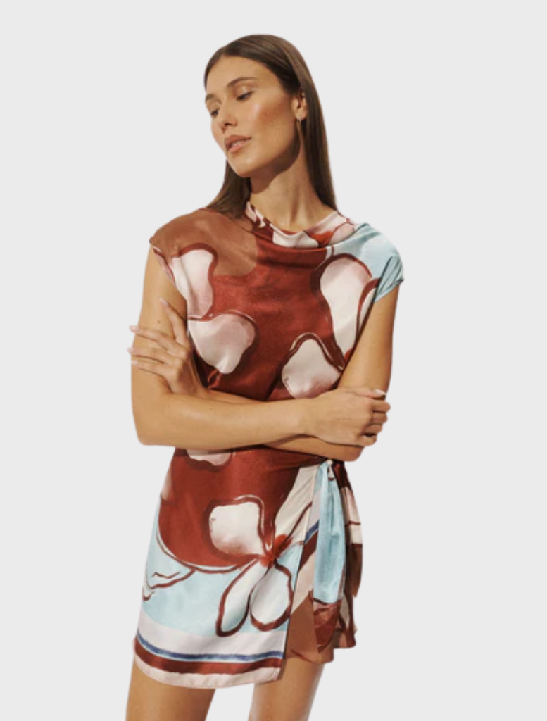 The Remy Mini Dress showcases a vibrant Marisol Bloom print, designed with a flattering fit and short sleeves for warm weather.