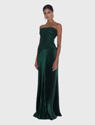 Strapless Maya Gown in Gotham Glitter features a ruched bodice and floor-length pleated skirt, ideal for formal occasions.