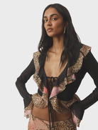 A chic frill cardigan made of mesh material, designed with a striking leopard print for a contemporary fashion touch.