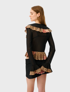 A chic frill cardigan made of mesh material, designed with a striking leopard print for a contemporary style.