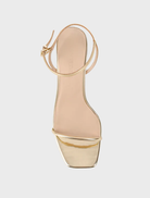 Elegant gold metallic leather high heel sandal, the Vicki Sandal, includes a strap and ankle strap for secure fit.
