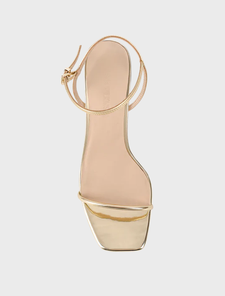 Elegant gold metallic leather high heel sandal, the Vicki Sandal, includes a strap and ankle strap for secure fit.
