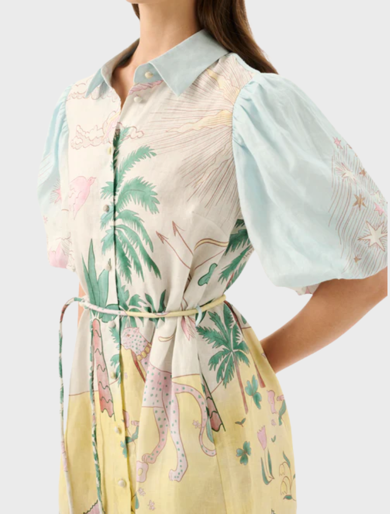 Model in the Berkley Mini Dress - Utopia, highlighting a cheerful design with palm trees and floral elements.