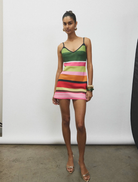 Elegant mini dress in emerald stripes, designed with a fitted shape and short sleeves for a chic, modern look.