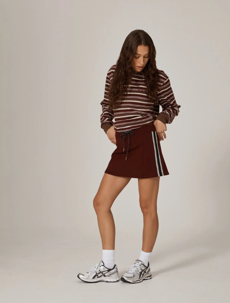 Burgundy Palmer mini skirt displayed on a white background, showcasing its stylish design and fabric texture.