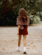 Burgundy mini skirt from Palmer, emphasizing its fashionable cut and color, displayed on a light background.
