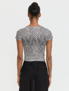 Stylish mini tee in black with a lattice texture, perfect for casual outings or as a layering piece.