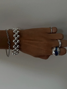 Stylish silver ring with bead accents, belonging to the Clover Bracelet line.
