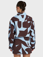 Contemporary Cropped Shacket with abstract Mirage design in brown and blue, perfect for effortless layering and travel.