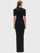 Fitted black knit polo with a ribbed texture, V neckline, short sleeves, and flap-detail chest pockets.