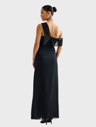 Back view of a woman wearing the Mirelle Dress in black, showcasing its elegant silhouette and design.