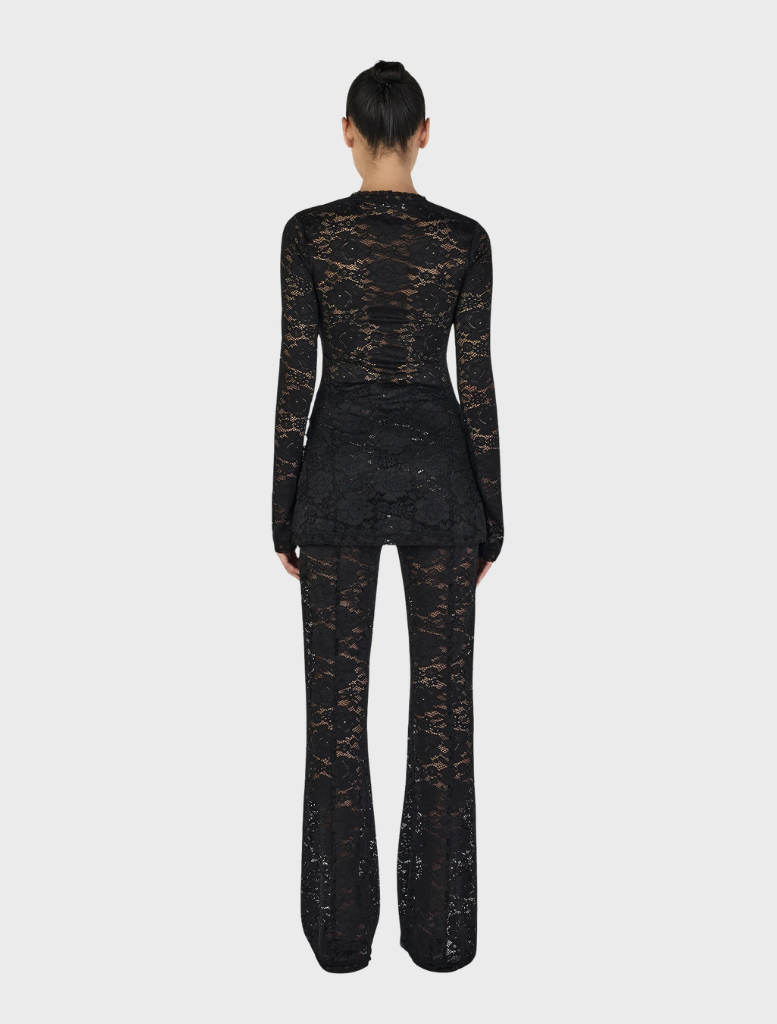 Misha's black long sleeve top, designed for comfort and versatility in any wardrobe.