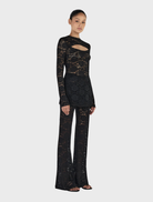 Classic black long sleeve top by Misha, ideal for both casual and formal settings.