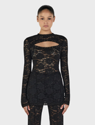 Black long sleeve top by Misha, featuring a classic design suitable for various occasions.
