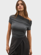 Dark heather grey Monica top displayed on a hanger, showcasing its soft fabric and casual style.