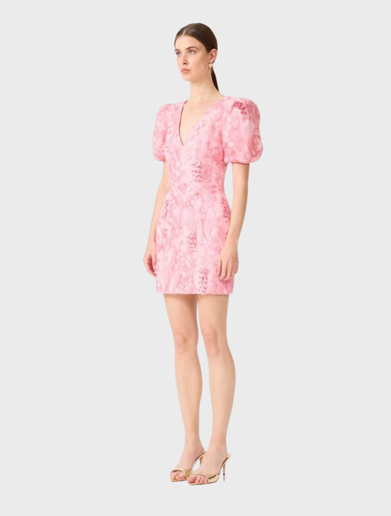 Monique's pink mini dress showcases puff sleeves and a playful skirt, ideal for summer outings or special events.