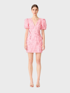 Pink Monique puff sleeve mini dress featuring a fitted bodice and flared skirt, perfect for casual or semi-formal occasions.