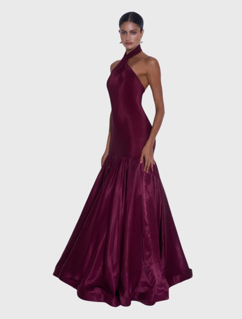 Elegant wine Montaigne Gown with halter neckline, fitted body, and flared hem, designed to sculpt and elongate the figure.