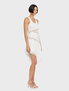 Elegant Echo Asymmetric Tank Dress with a fitted cut, asymmetric hem, and sheer lace panels, perfect for refined occasions.
