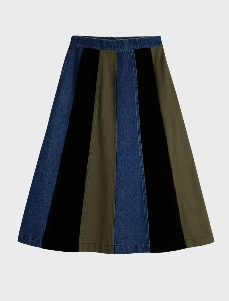 Multi-colored Evase skirt displayed on a hanger, showcasing its flowing design and vibrant patterns.