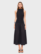 Black high neck maxi dress featuring a flowing silhouette and elegant design, perfect for formal or casual occasions.