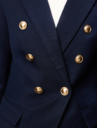 Navy Legacy Blazer on a hanger, highlighting its sophisticated design and tailored appearance.