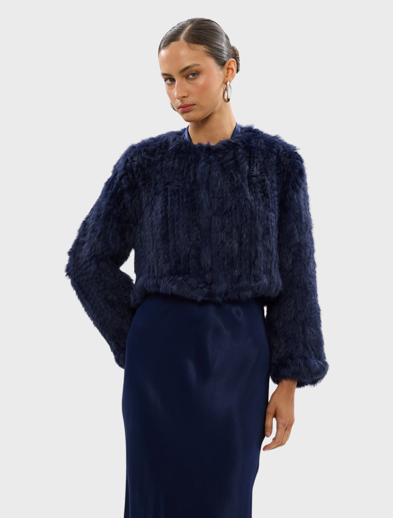Navy Lola Crop Jacket with a modern cut, ideal for layering over outfits for a chic look.