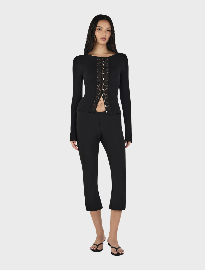 Nina Cardi Top in black, presented flat, emphasizing its sleek silhouette and contemporary style for everyday wear.