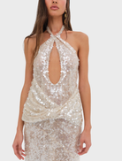 Elegant nude maxi dress adorned with sequins, showcasing a fitted silhouette and a graceful, flowing skirt.