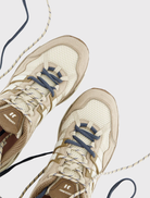 Retro-inspired sneaker designed for running, featuring a cushioned insole, breathable mesh, and reinforced stitching.