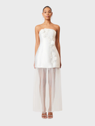 White strapless maxi dress with an oleander floral pattern, perfect for summer events and casual outings.