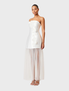 Strapless white maxi dress adorned with a colorful oleander floral design, suitable for outdoor gatherings and parties.