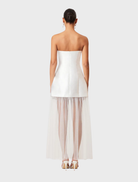 Chic strapless maxi dress in white, embellished with oleander flowers, perfect for beach outings or garden parties.