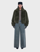 Olive faux fur bomber jacket with an oversized design, featuring a standard collar, zipper closure, side pockets, and elastic cuffs.
