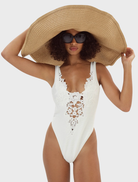 White Lelani one-piece swimsuit with a flattering fit, ideal for a fashionable day at the beach or pool.