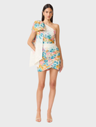 Elegant one-shoulder mini dress in a multi floral design, ideal for summer events and gatherings.