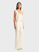 Ivory Otis Pant draped elegantly, emphasizing its modern style and color.
